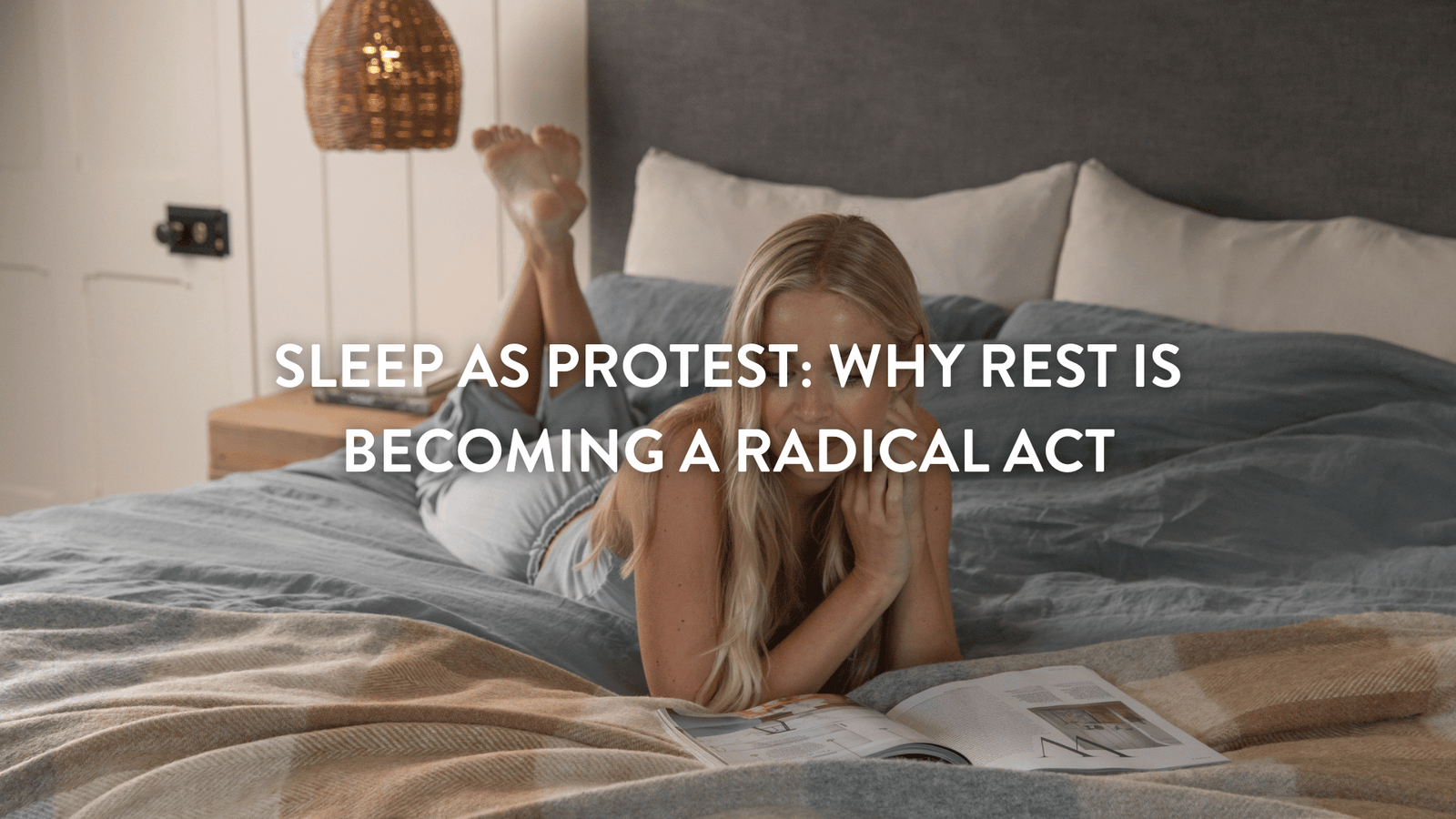 Person lying on top of a duvet reading a magazine relaxing