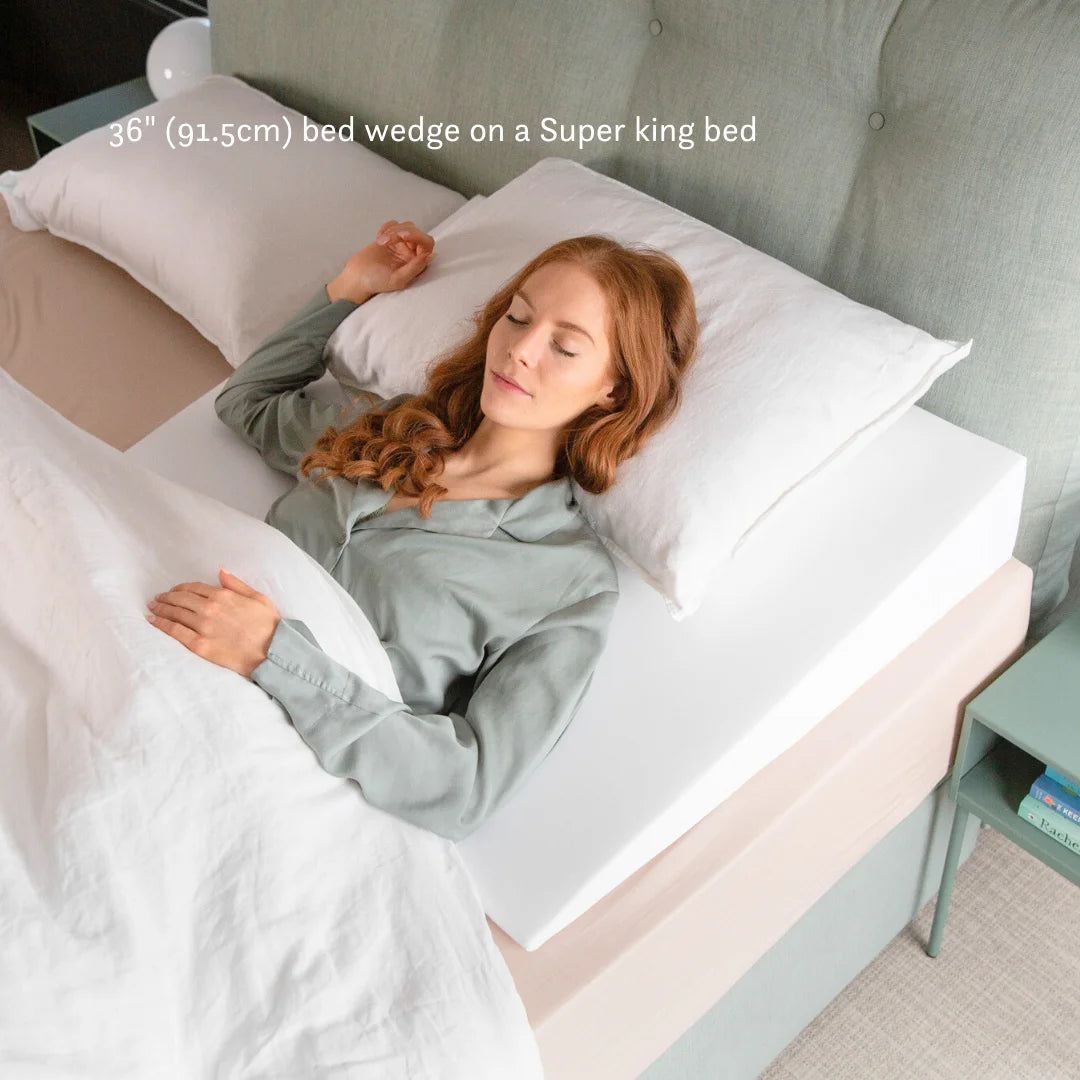 Green palm leaf beside two blank white cards on a white background.