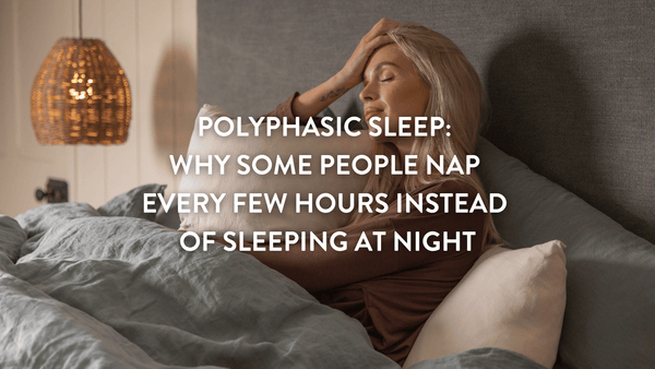 Person sitting up in a double bed with their eyes shut leaning against a Putnams pillow 