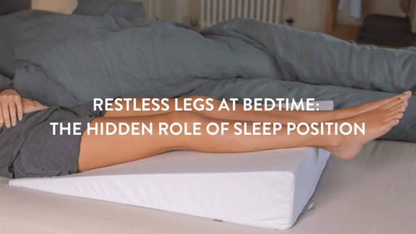 Person lying on a bed using the Putnams bed wedge to soothe restless legs at night