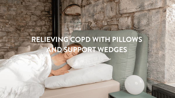 Person sleeping in bed on a Putnams bed wedge