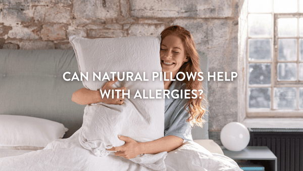 Person hugging a Putnams natural pillow whilst sitting up in bed
