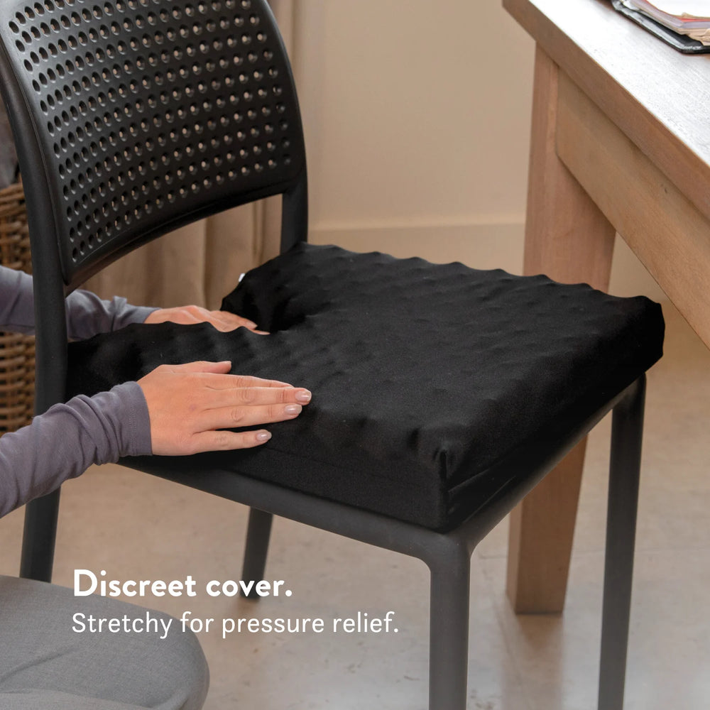 Tailbone Pain Cushion with a cut out for pressure relief at the back of the cushion. Stretch navy blue or black cover available in different sizes. High density foam with a 2 year guarantee.