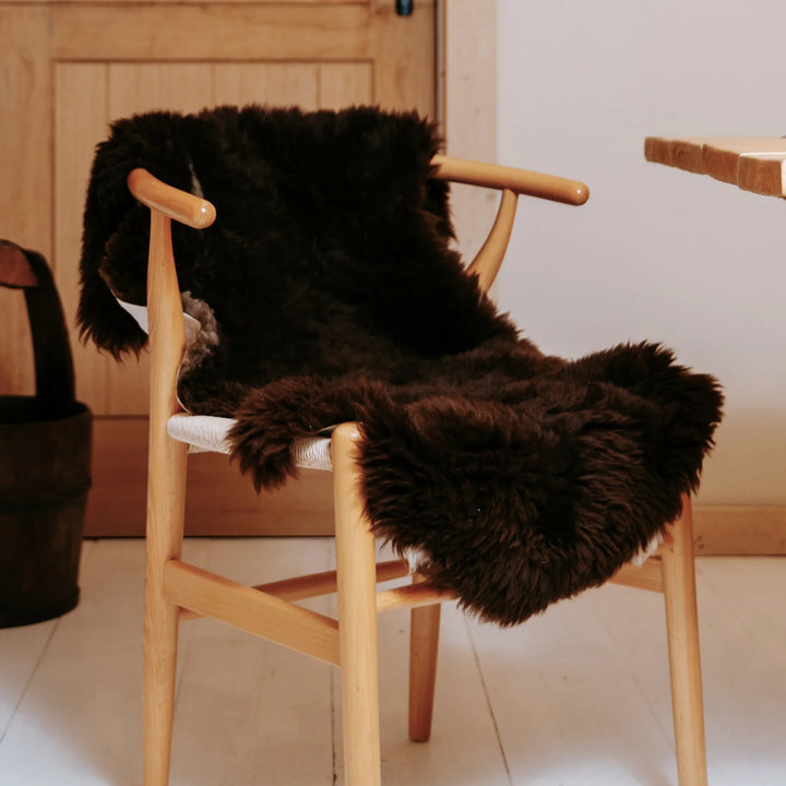 real sheepskin British rug throw brown super soft long pile very fluffy on a chair